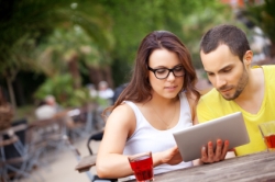 Picture of a male and female student looking at an ipad