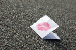 note sealed with a kiss, discarded in playground