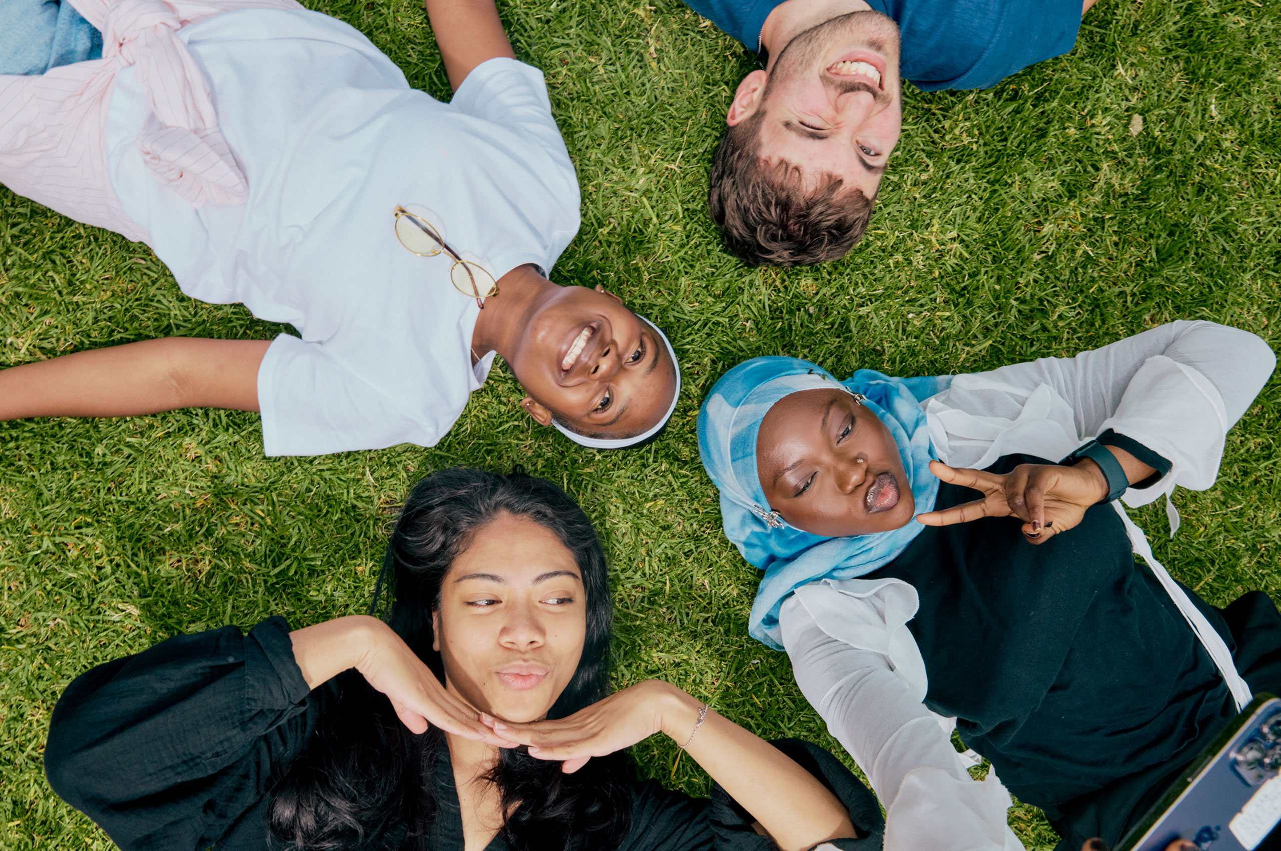 Image of students lying down on grass