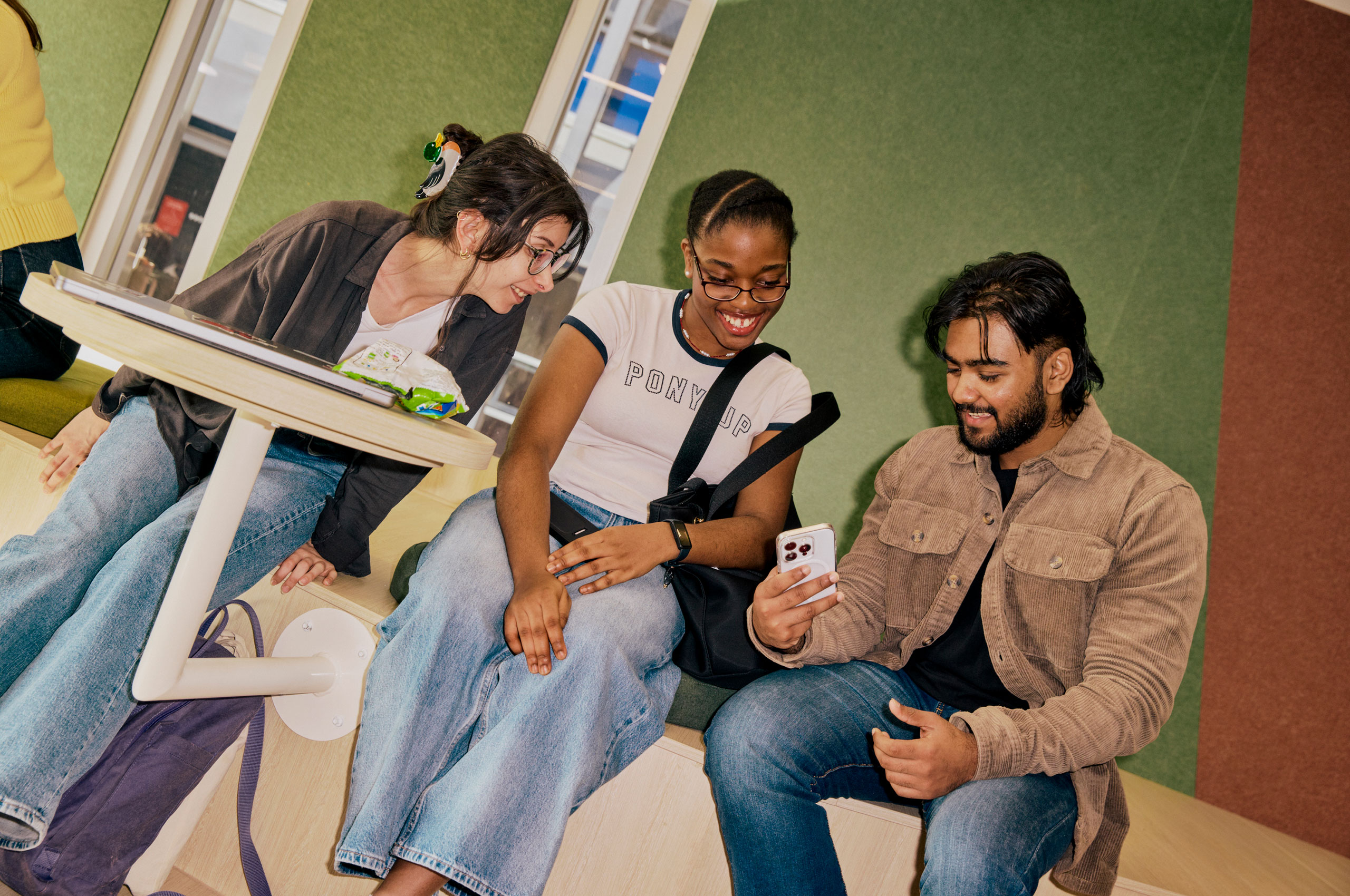Image of students sitting on bench in campus
