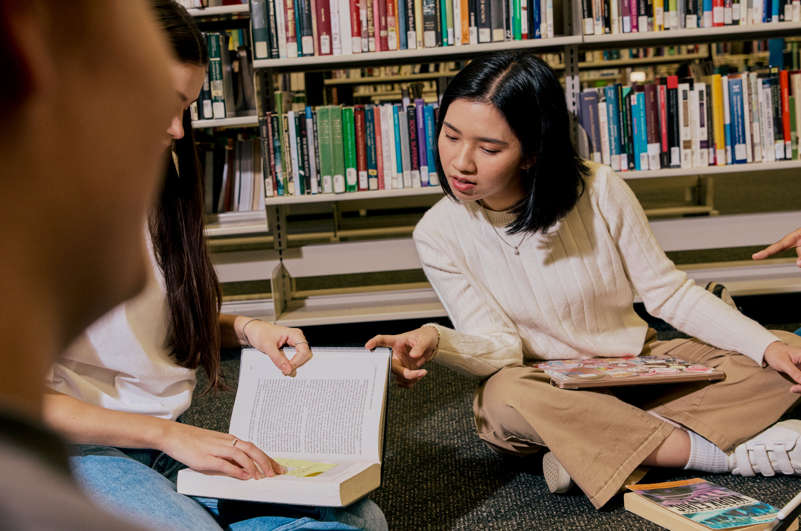 Image of students studying on library floor