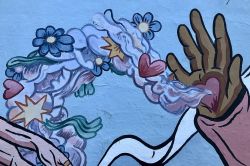 An artwork with a hand and flowers