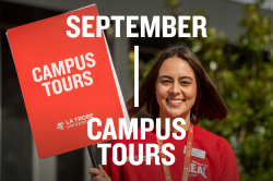 Ambassador holding tour sign