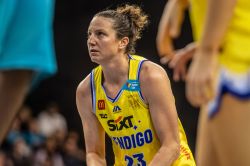 Kelsey Griffin holding a basketball in court.