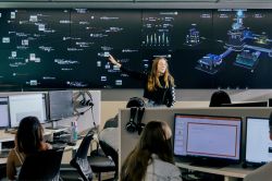 Students learning with data visualisations displayed in a computer lab.