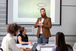 Lecturer presenting to students during a university class.