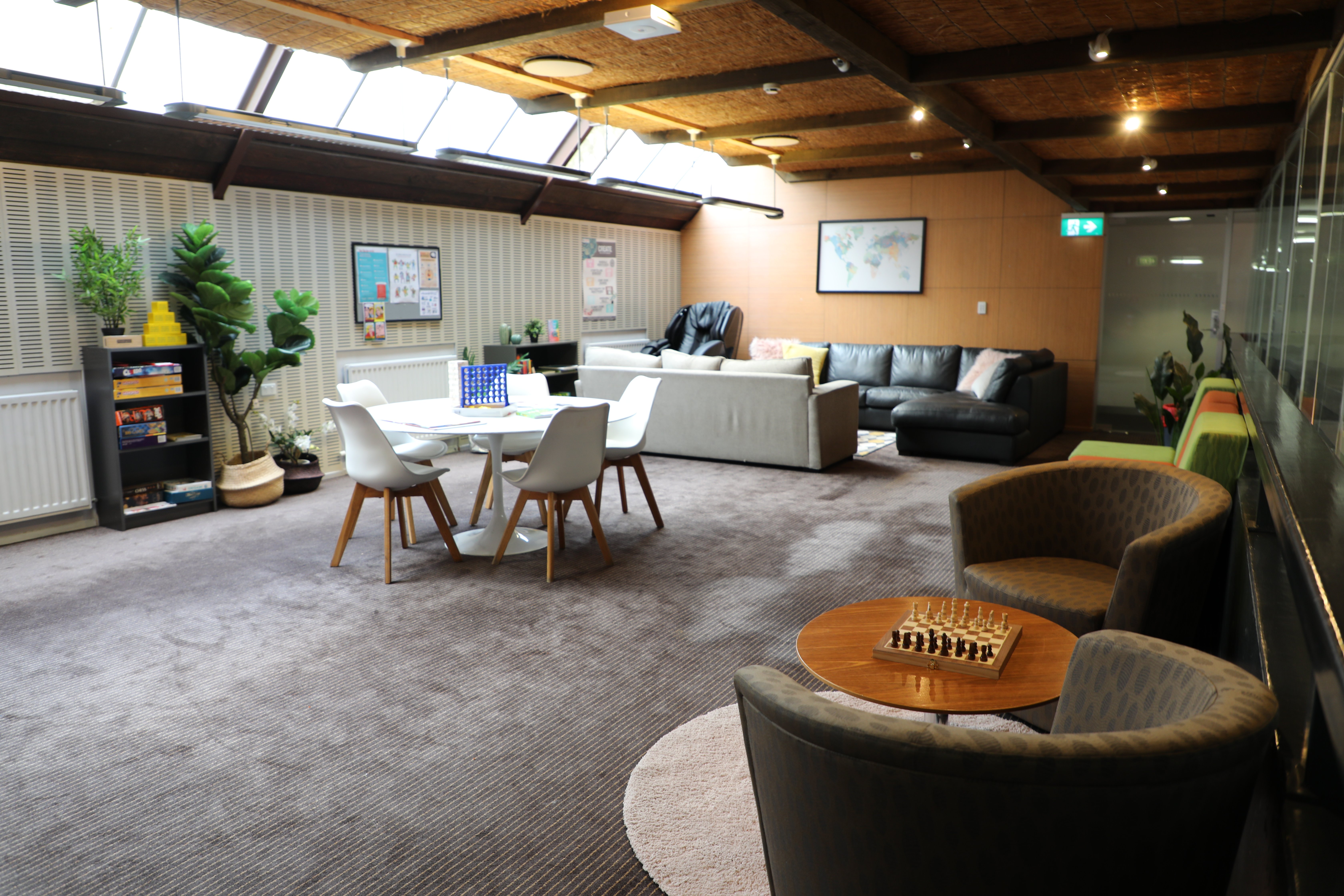 Lounges, massage chair and recreation acitivities, showing Chisholm College common room.