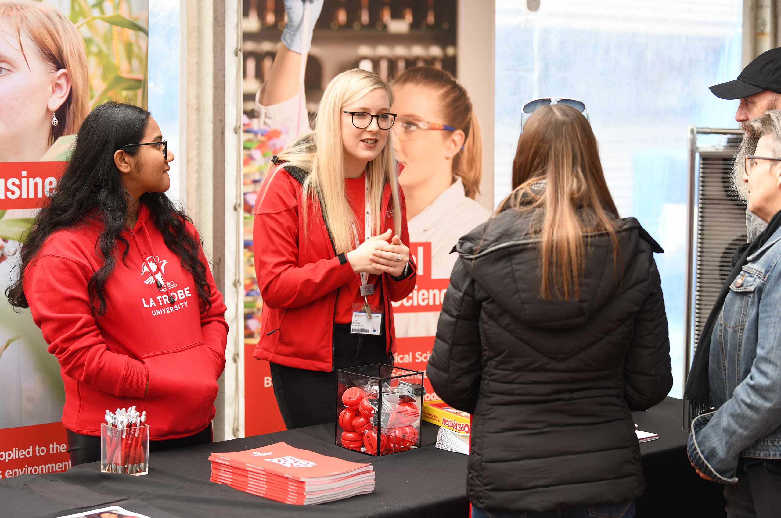 La Trobe staff and prospective students talking at an event.