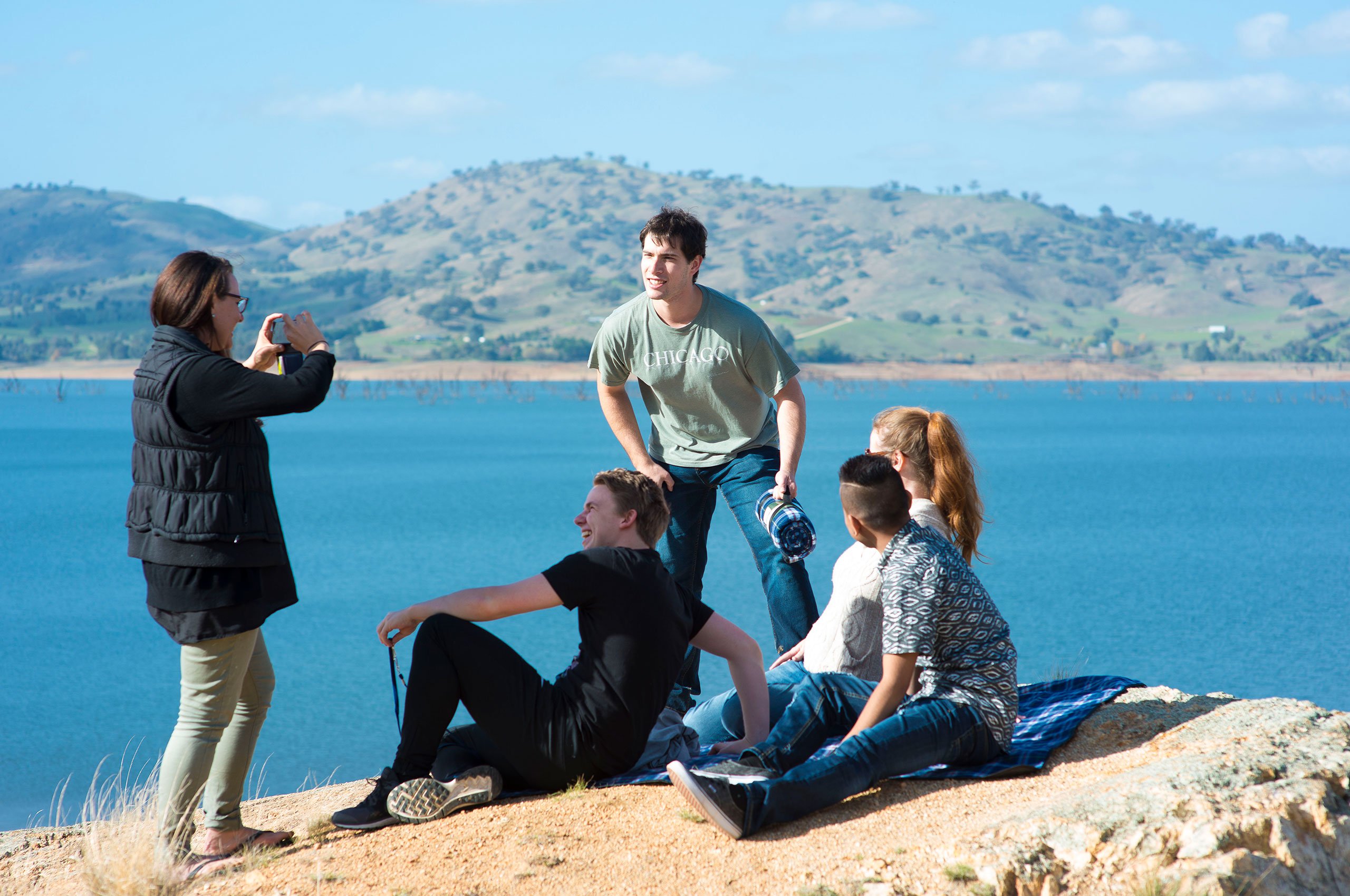 Students taking photo with river in background