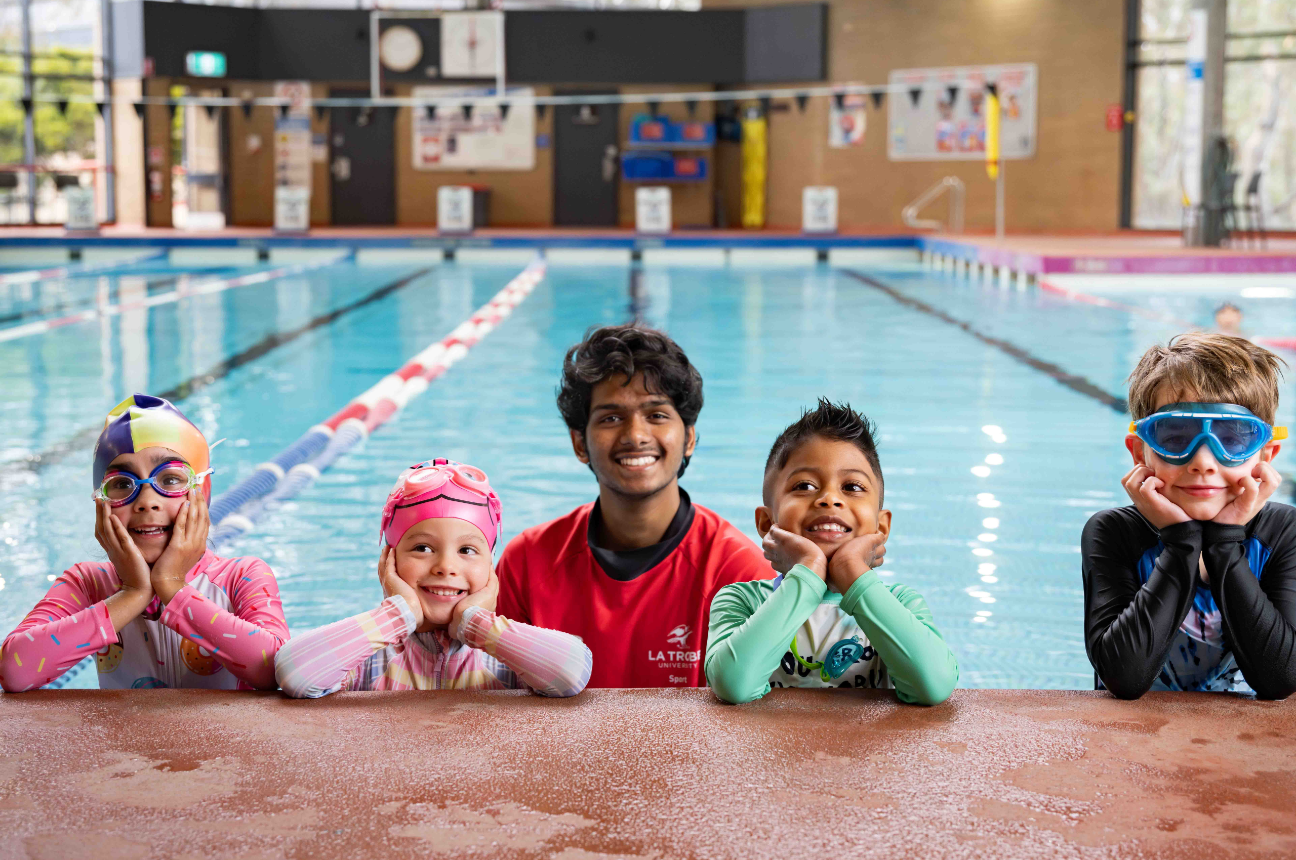 Swim School Kids Group photo with four kids in pool
