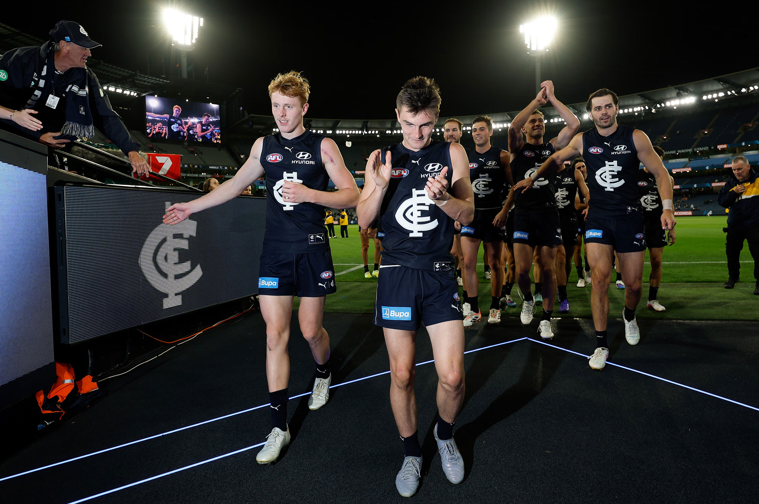Carlton team walking off the pitch