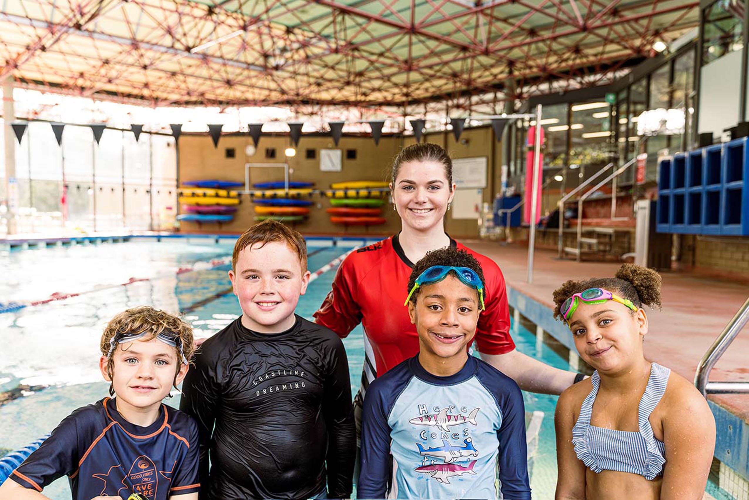 Kids gathering for a photo after their pool activities