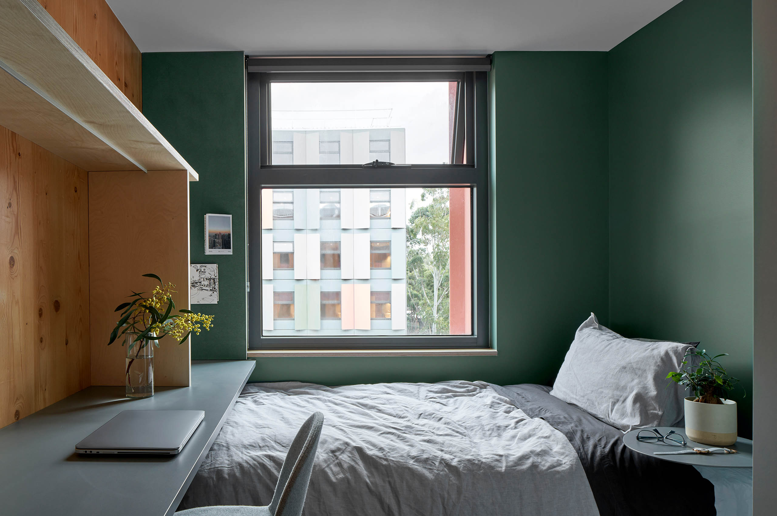 An example of a bedroom in a shared apartment. Each room has an exposed Cross Laminated Timber feature wall.