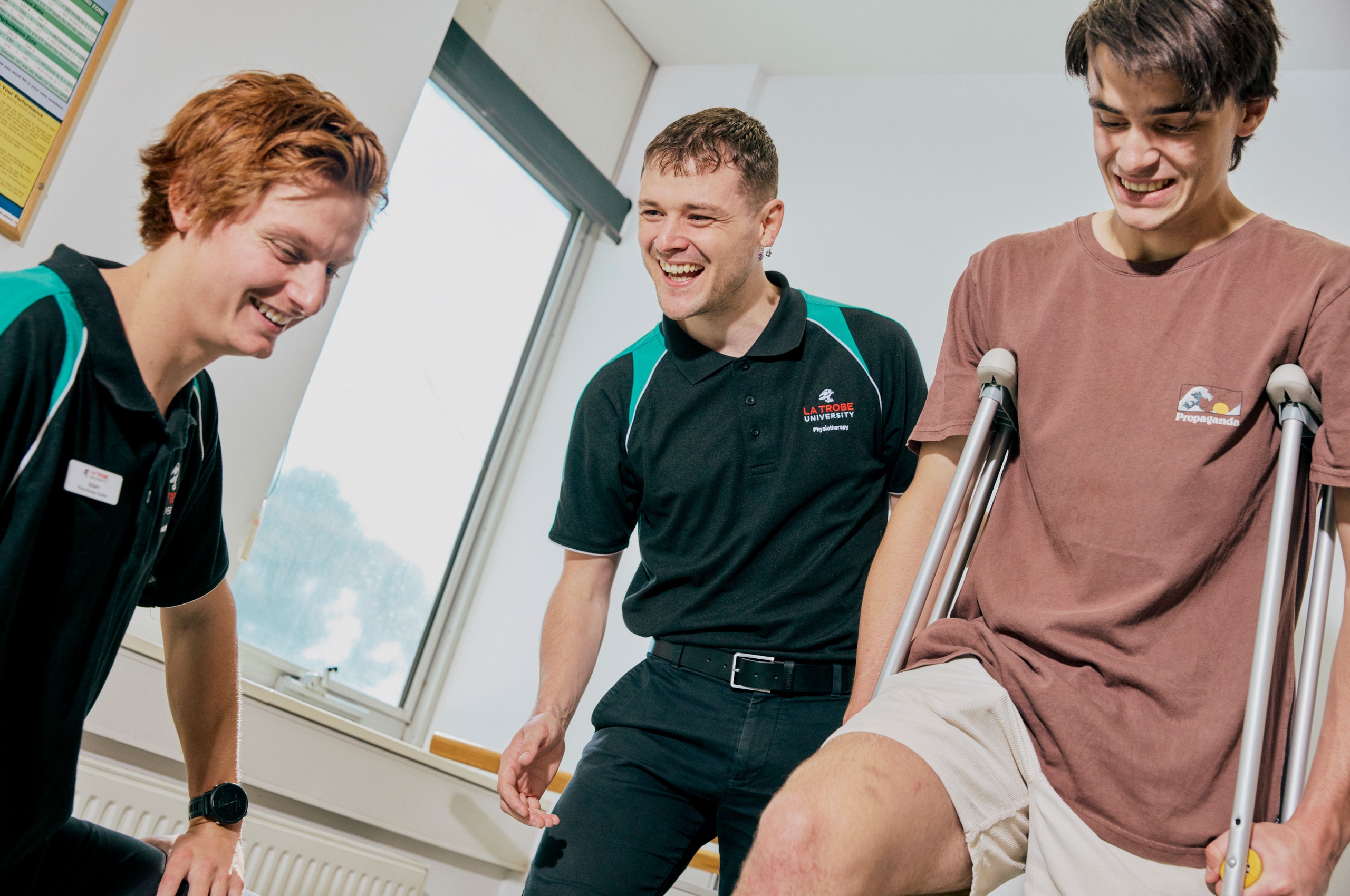 Students helping patient in crutches