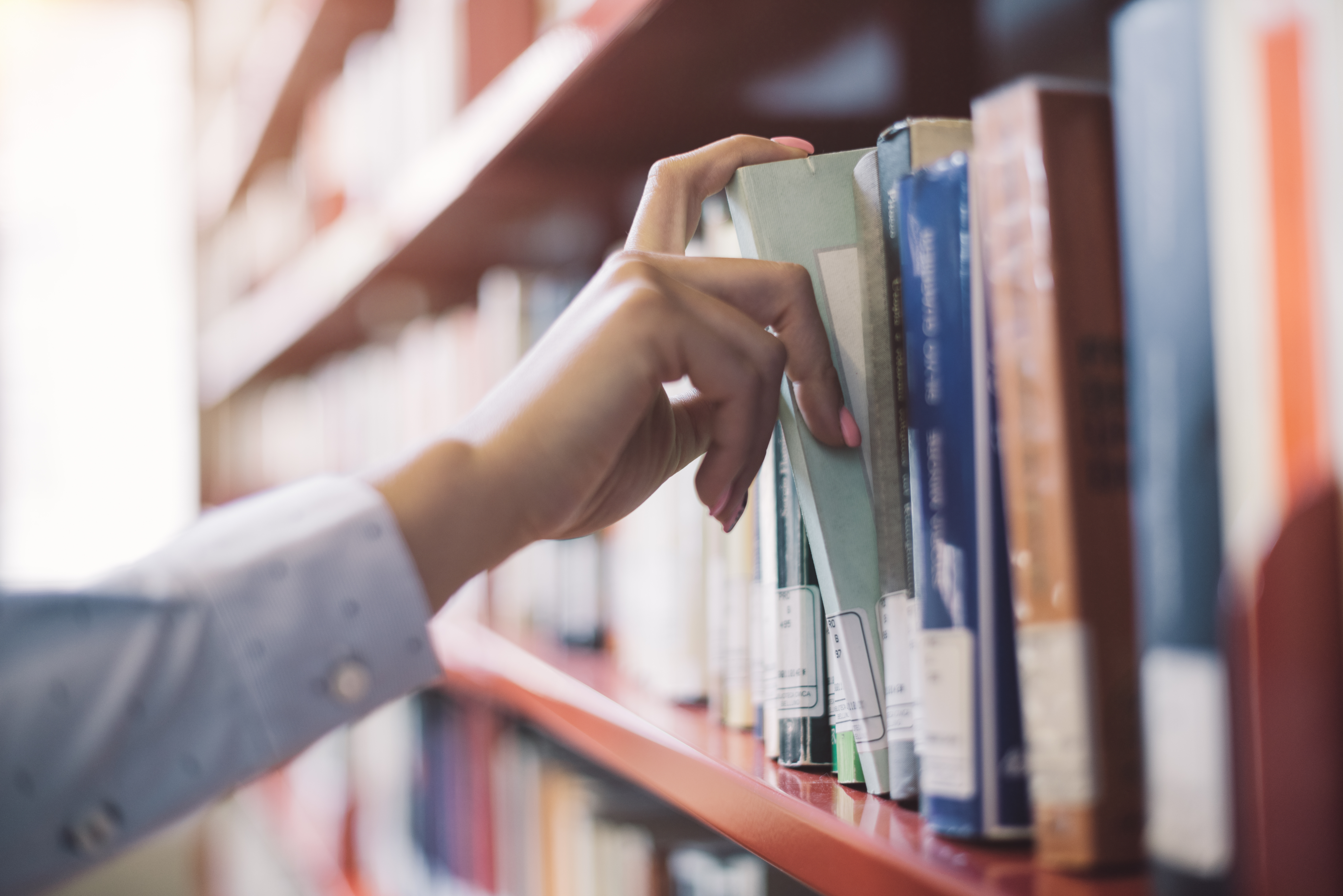 Taking a book from the library shelf