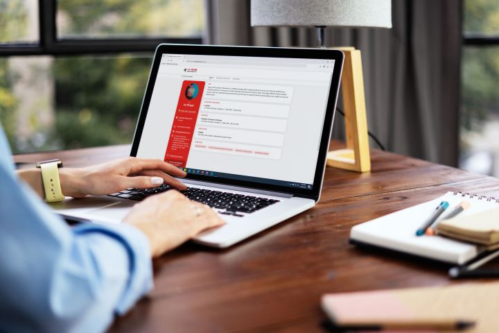 A woman using a laptop to view her academic profile