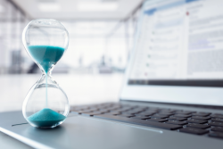 Hourglass on laptop keyboard