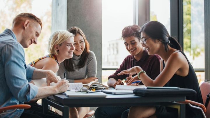 Group of students studying inside together at a table