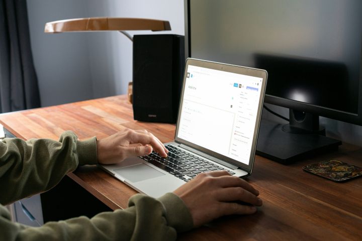 Person typing on a laptop at their desk
