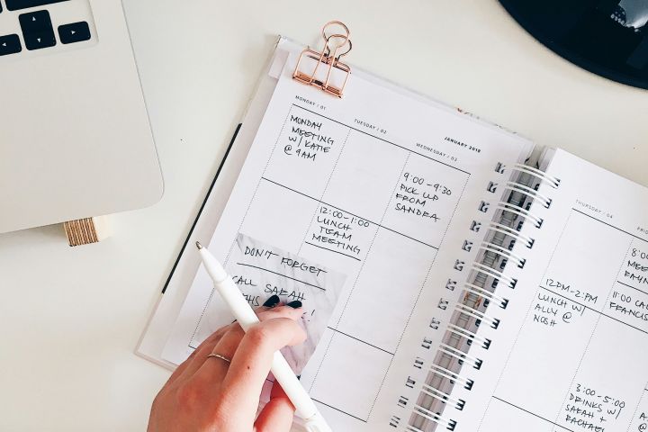 Person writing in a planner