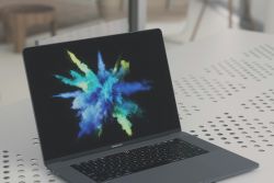 Laptop with colours bursting on screen