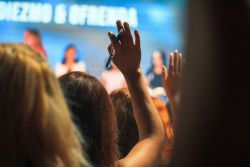 A person raising their hand to ask a question