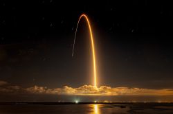 A sounding rocket doing a parabolic flight in the night sky.