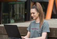 Student sitting outside using a laptop