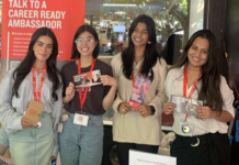 Career Ready Ambassadors holding flyers and standing at a booth
