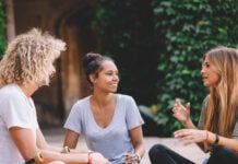 A group of three students chatting