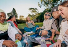 Students sitting outside on the grass