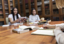 Students studying and writing in a notebook