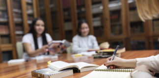 Students studying and writing in a notebook