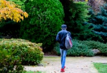 The back of a student walking away in the international garden
