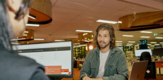 A student talking to an advisor at a desk