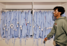Student walking past lab coats