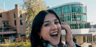 An excited student smiling and looking at the camera