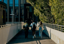 Three students walking around the Bundoora campus.