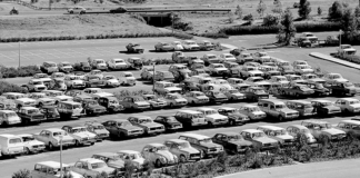 A vintage black and white photo of cars parked at a La Trobe campus