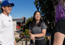 Three students chatting and laughing outside