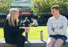 Two students in conversation sitting in the Agora