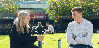 Two students in conversation sitting in the Agora