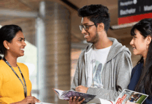 Three students talking and reading books