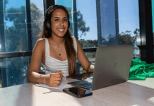 Student wearing headphones working on laptop