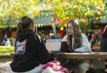 Two students sitting at a table in the Agora