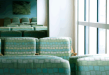 An empty wait room with green chairs