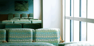 An empty wait room with green chairs