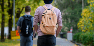 Two students walking along a path