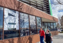 Two students walking outside the Northern Study Hub building