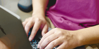 Person typing on laptop